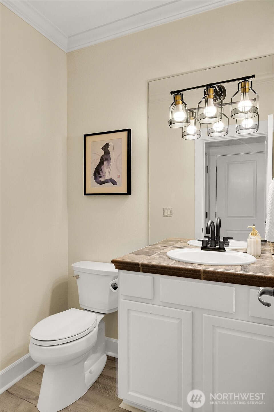 1011 North 27th Place Renton, WA 98056 - Photo 6 of 40 a bathroom with a toilet a sink and mirror