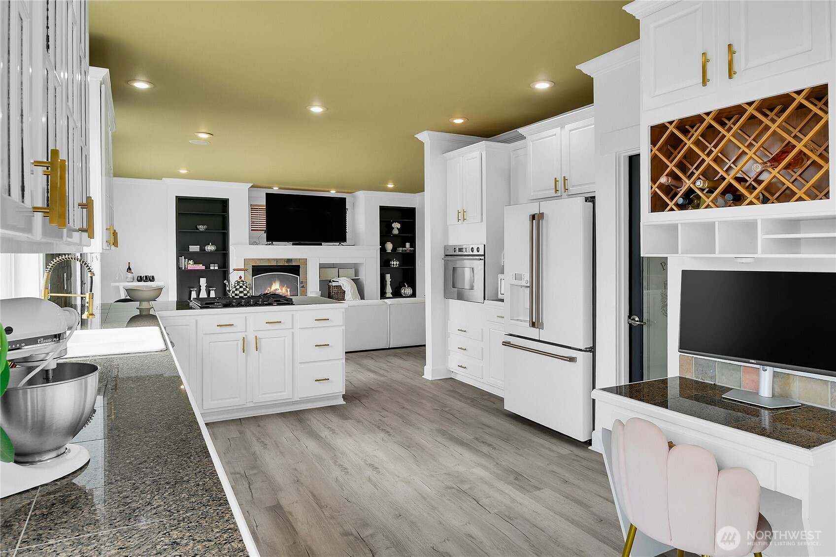 1011 North 27th Place Renton, WA 98056 - Photo 10 of 40 a large white kitchen with stainless steel appliances kitchen island granite countertop a refrigerator a stove a microwave oven a sink with island and chairs