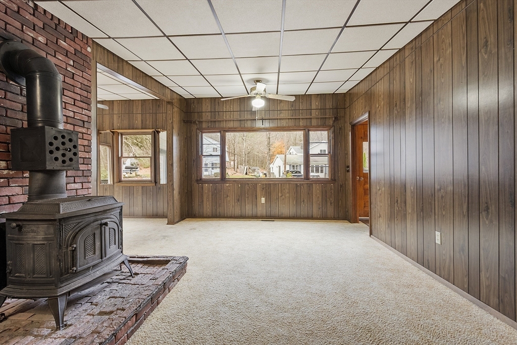 7 Hickory Lane Lunenburg, MA 01462 - Photo 16 of 40 a view of an empty room with a fireplace and a window