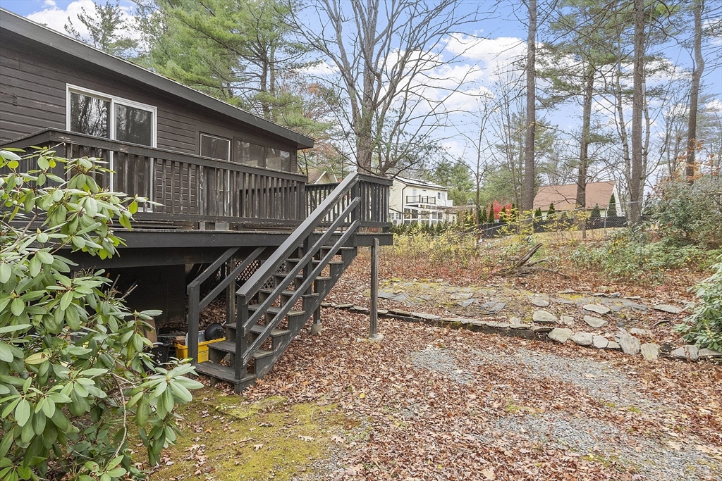 7 Hickory Lane Lunenburg, MA 01462 - Photo 4 of 40 a view of a house with a wooden deck and trees