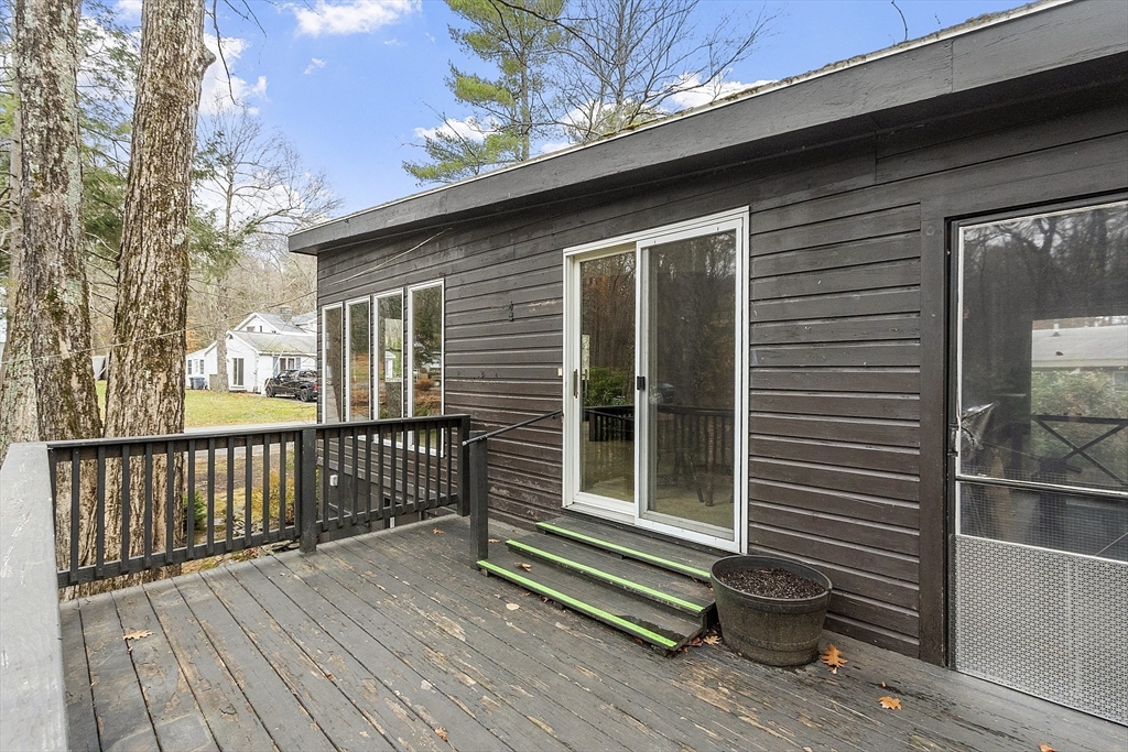 7 Hickory Lane Lunenburg, MA 01462 - Photo 6 of 40 a view of a house with a large window and wooden fence