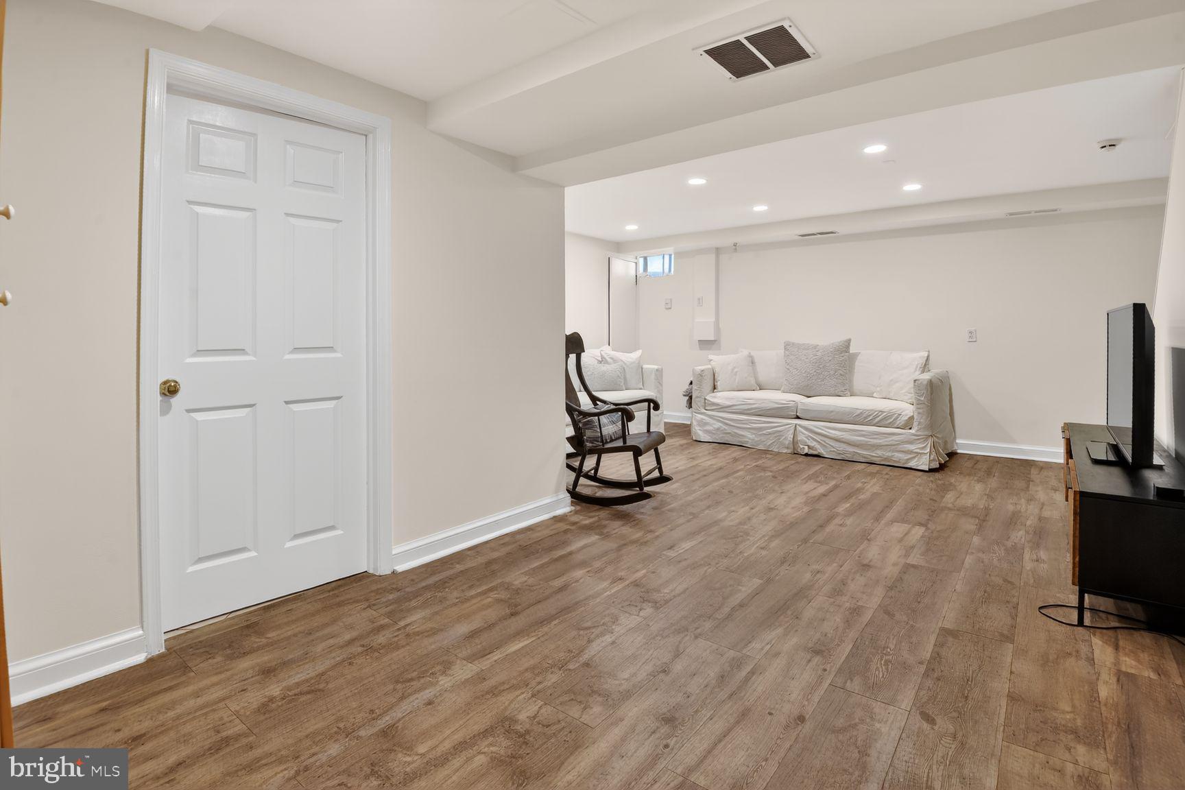 5225 Elliott Road Bethesda, MD 20816 - Photo 29 of 37 a living room with furniture and a flat screen tv