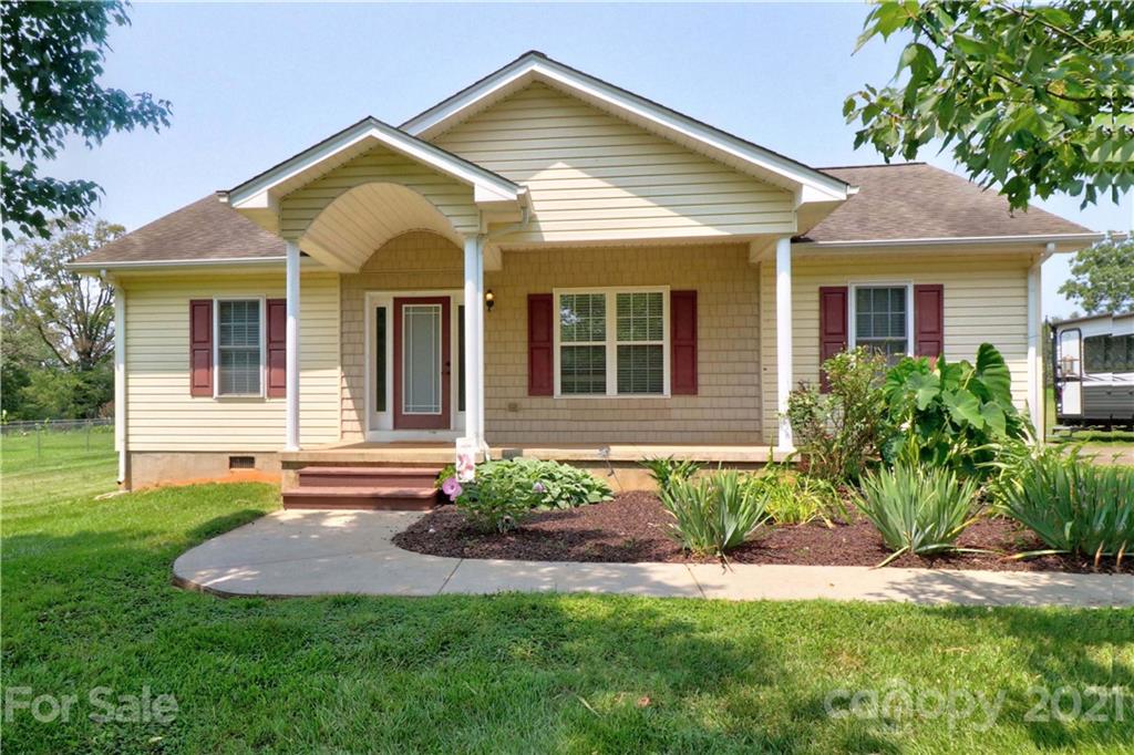 1045 Tabor Road Olin, NC 28660 - Photo 1 of 44 a front view of a house with a yard