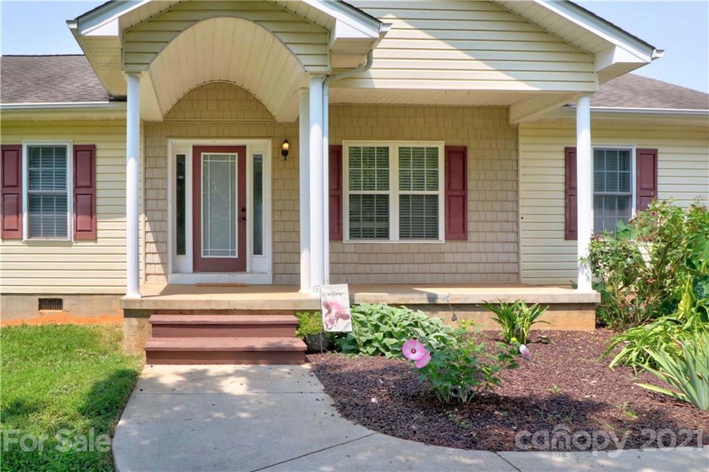 1045 Tabor Road Olin, NC 28660 - Photo 2 of 44 a front view of a house with a yard