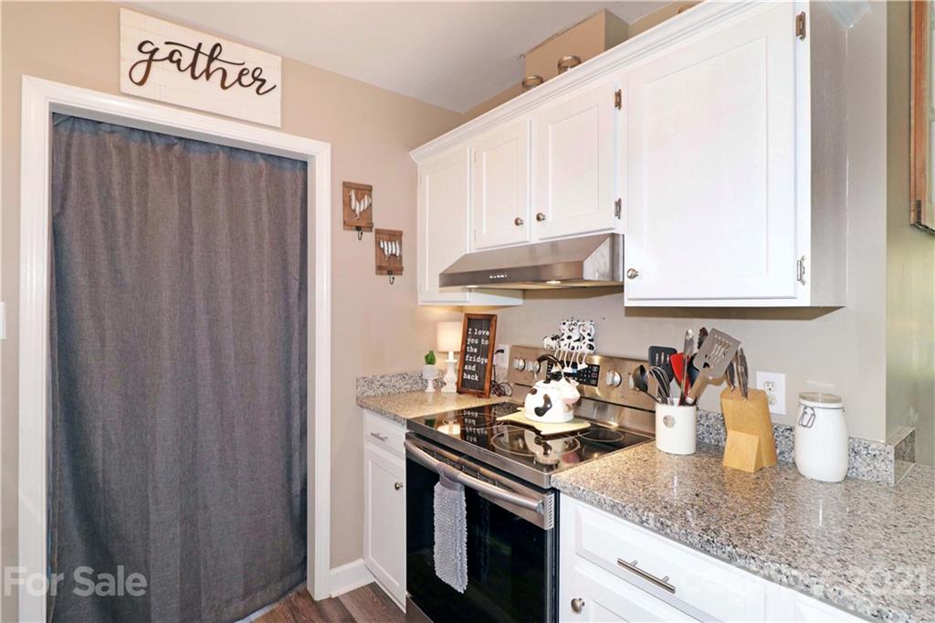 1045 Tabor Road Olin, NC 28660 - Photo 13 of 44 a kitchen with a sink a stove and cabinets