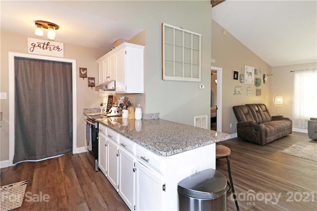 1045 Tabor Road Olin, NC 28660 - Photo 14 of 44 a kitchen with stainless steel appliances granite countertop a sink stove and refrigerator