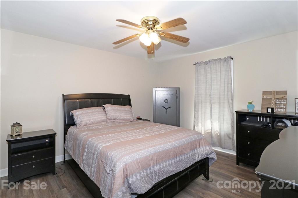 1045 Tabor Road Olin, NC 28660 - Photo 18 of 44 a bedroom with a bed and a chandelier