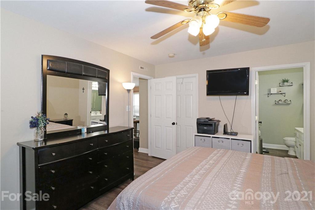 1045 Tabor Road Olin, NC 28660 - Photo 19 of 44 a spacious bedroom with a bed and a flat screen tv
