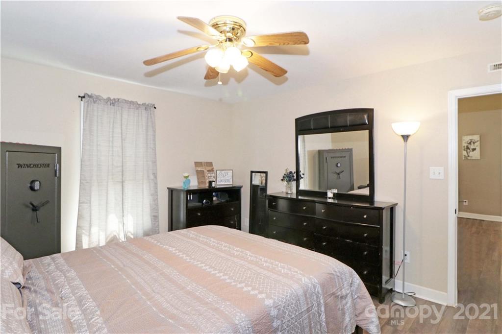 1045 Tabor Road Olin, NC 28660 - Photo 20 of 44 a bedroom with a bed and a chandelier