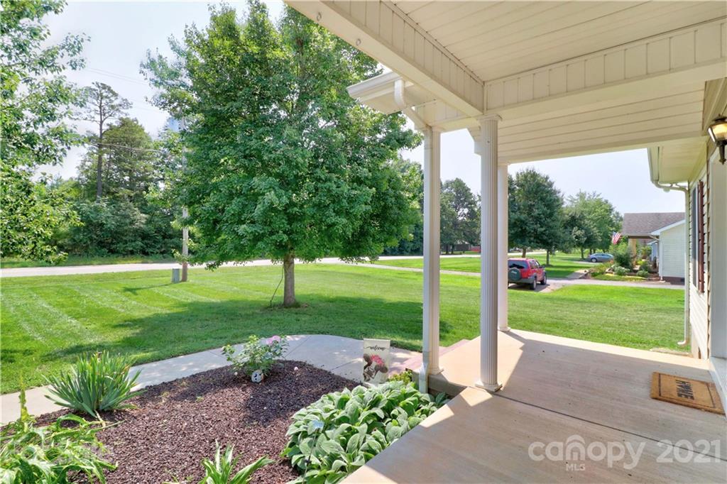 1045 Tabor Road Olin, NC 28660 - Photo 3 of 44 a view of a garden with a large tree