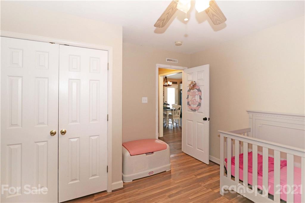 1045 Tabor Road Olin, NC 28660 - Photo 23 of 44 a view of a hallway with wooden floor and closet