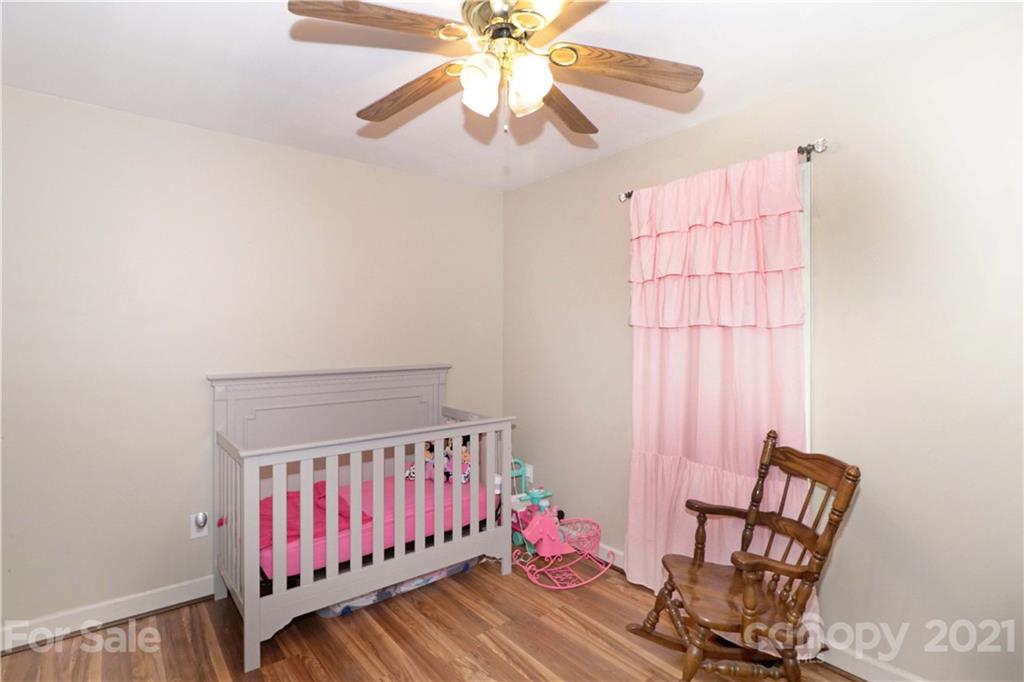 1045 Tabor Road Olin, NC 28660 - Photo 25 of 44 a bedroom with furniture and a window