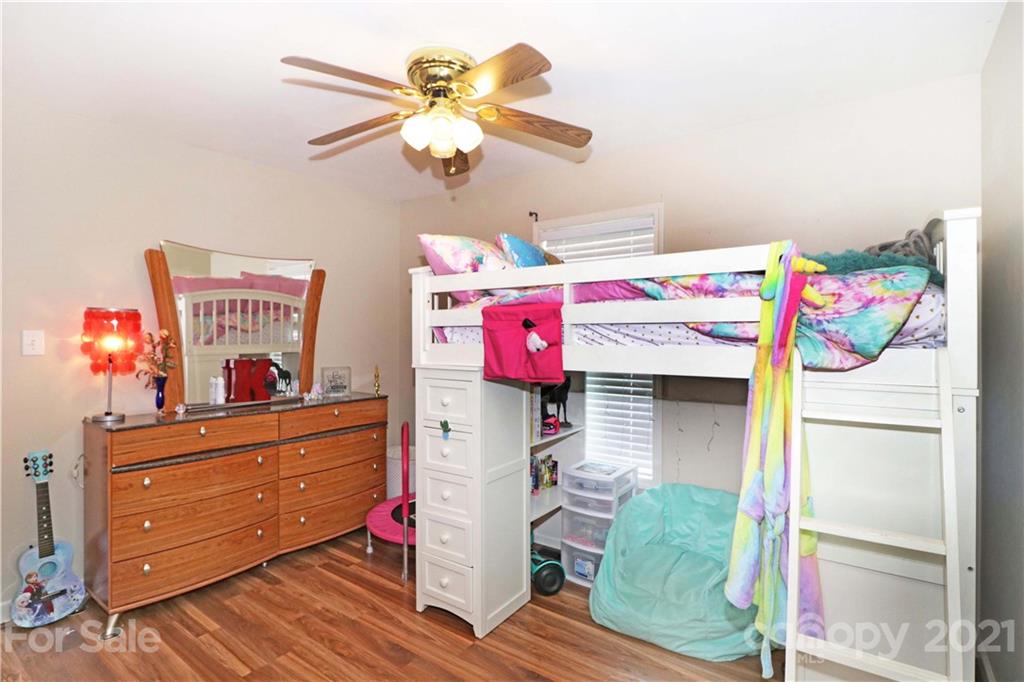 1045 Tabor Road Olin, NC 28660 - Photo 27 of 44 a bedroom with a bed and a chandelier