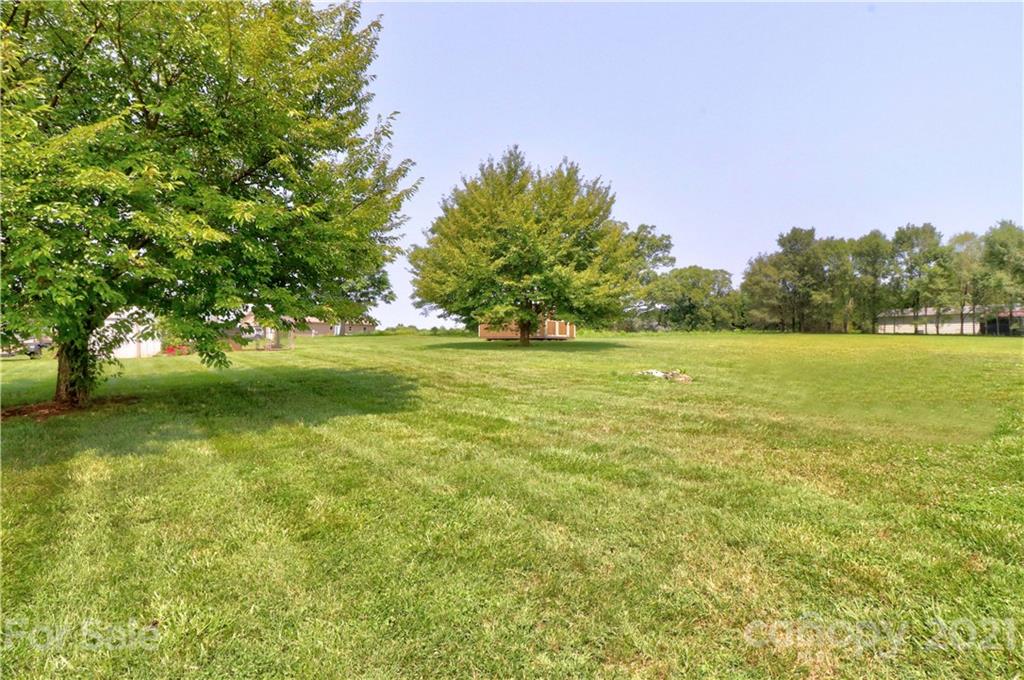 1045 Tabor Road Olin, NC 28660 - Photo 35 of 44 a view of a field with an trees in the background