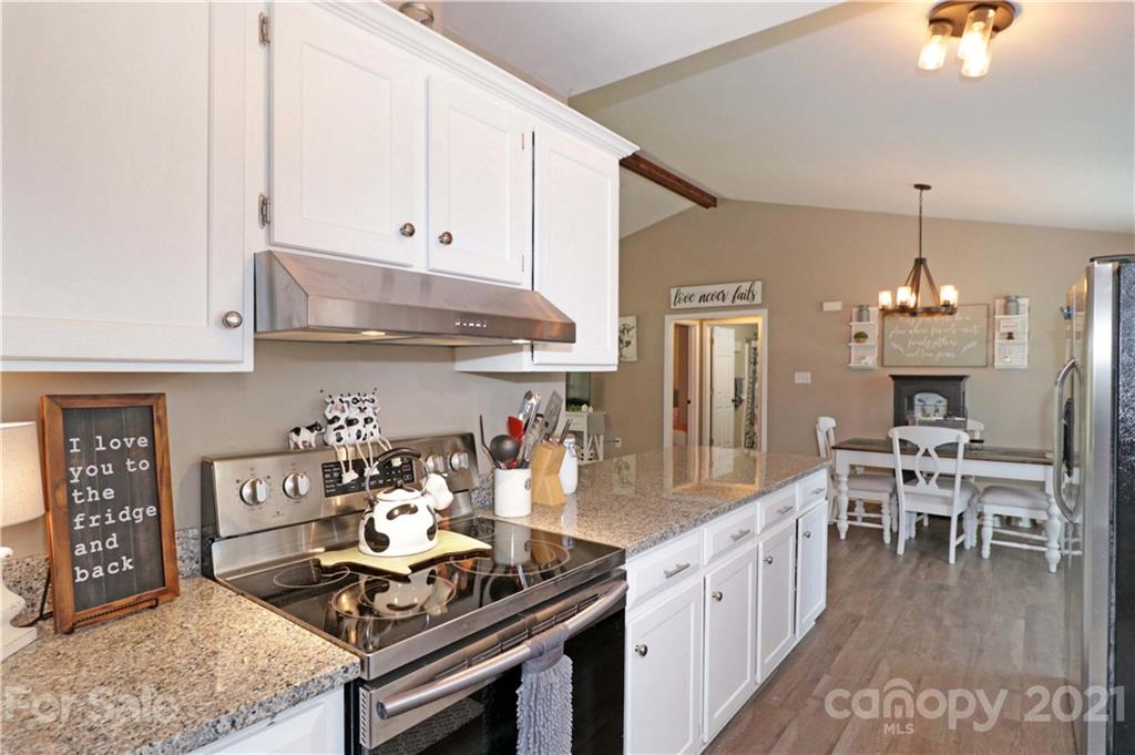 1045 Tabor Road Olin, NC 28660 - Photo 9 of 44 a kitchen with stainless steel appliances granite countertop a stove a sink and a refrigerator