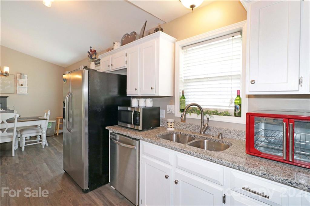1045 Tabor Road Olin, NC 28660 - Photo 10 of 44 a kitchen with stainless steel appliances sink refrigerator and microwave