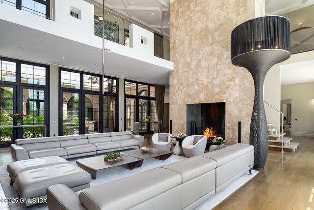 a living room with furniture a large window and a flat screen tv