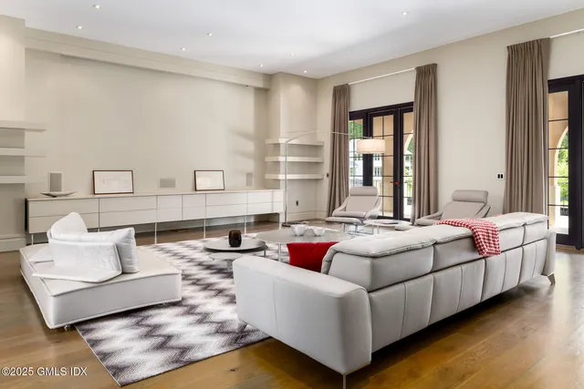 a bedroom with a bed a couch and a window