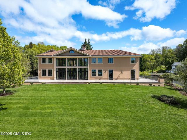 an aerial view of a house with swimming pool and lake view