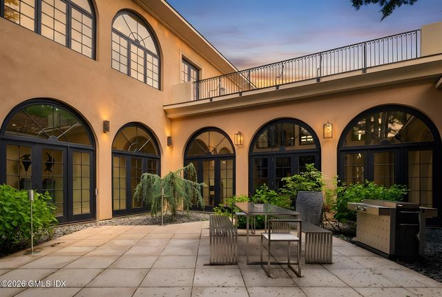 a living room with furniture and floor to ceiling windows
