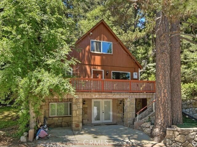 1255 Bear Springs Road Rimforest, CA 92378 - Photo 1 of 1 a front view of a house with a tree