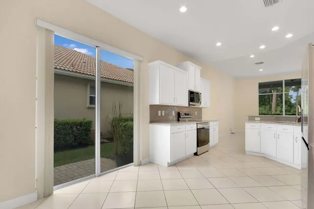 a bathroom with a bathtub a double vanity sink and a mirror