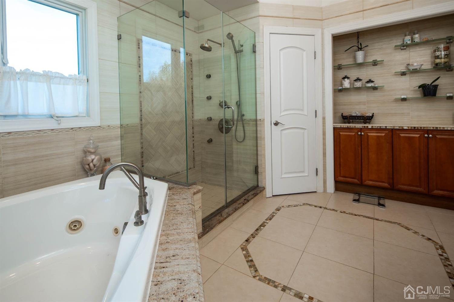 329 Pleasant Valley Road Old Bridge, NJ 08857 - Photo 41 of 75 Jacuzzi jetted tub, built, extra built in cabinets, beautiful frameless shower, gorgeous tile.