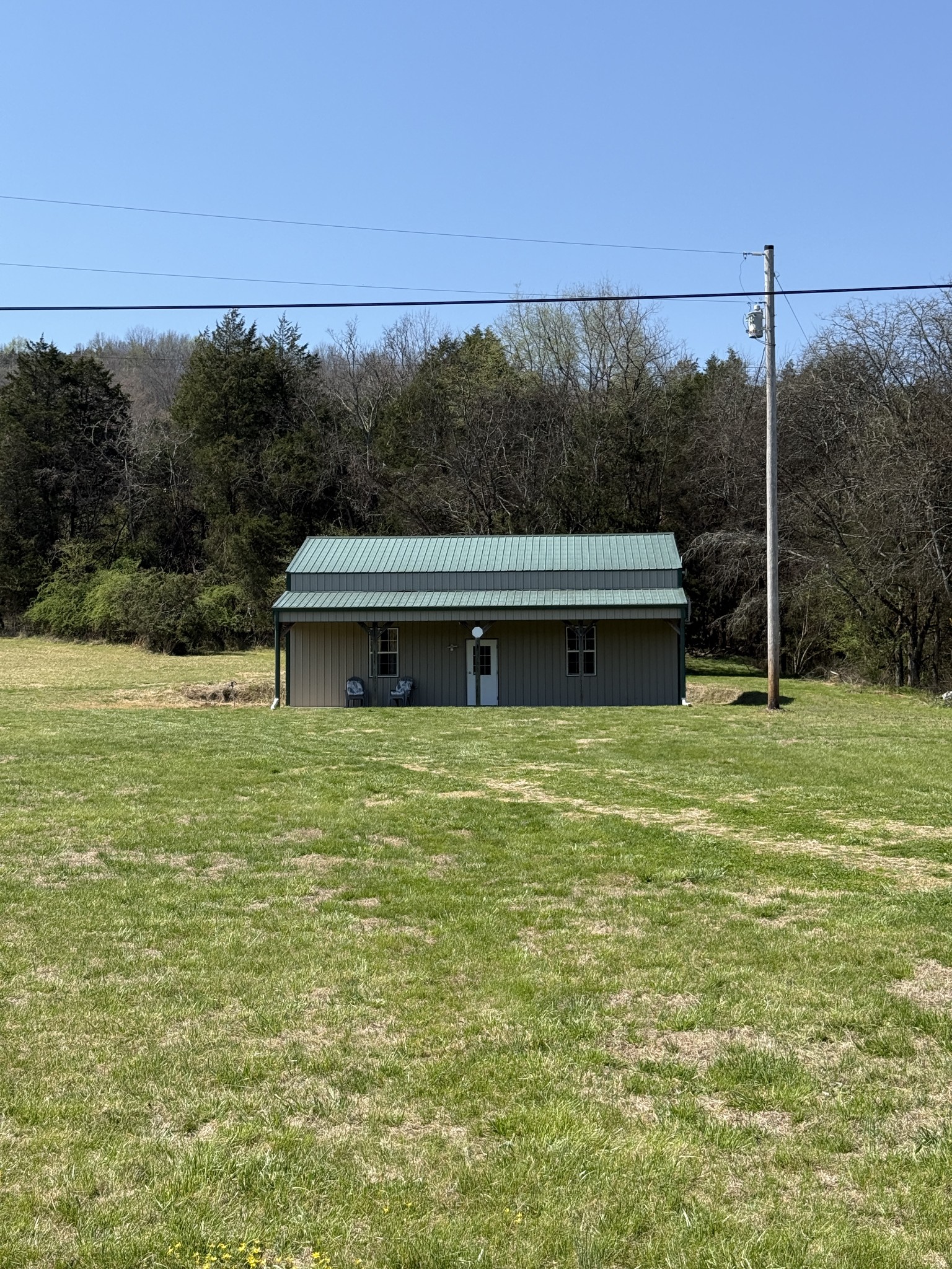855 Lick Creek Road Hartsville, TN 37074 - Photo 3 of 76 a view of a green field with trees in the background