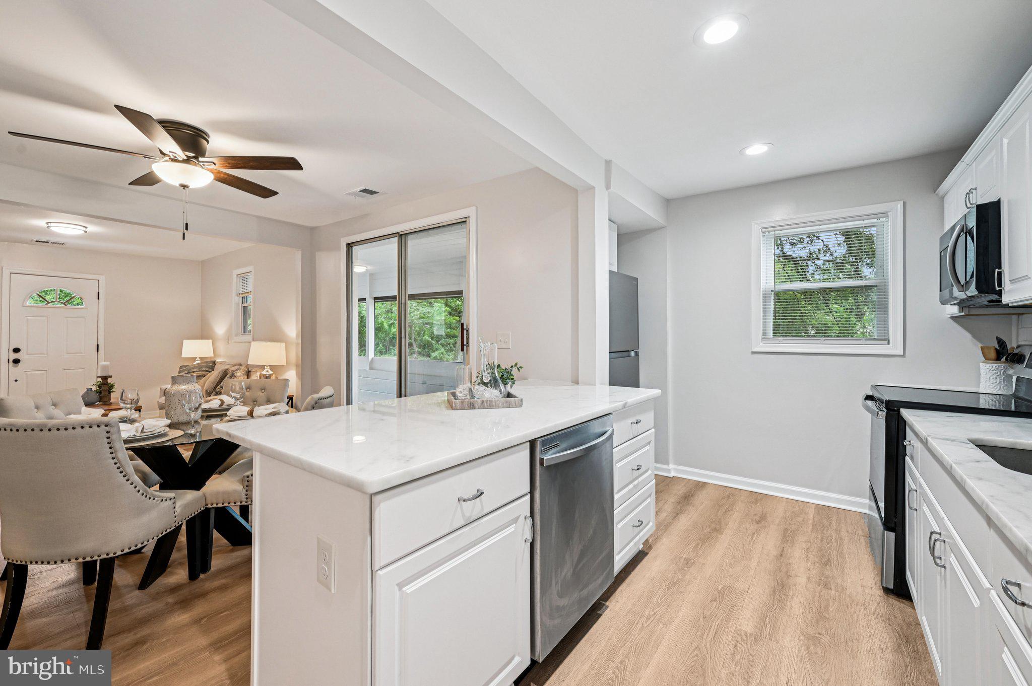 3569 Whiskey Bottom Road Laurel, MD 20724 - Photo 27 of 53 a kitchen with a stove a sink a dining table and chairs