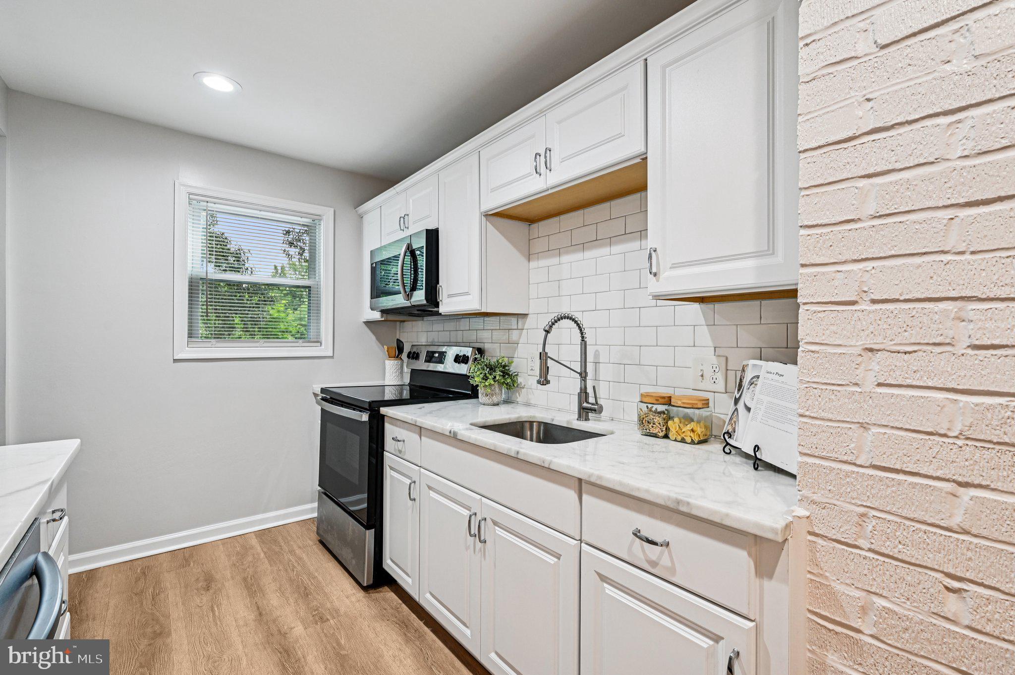 3569 Whiskey Bottom Road Laurel, MD 20724 - Photo 28 of 53 a kitchen with stainless steel appliances granite countertop a sink stove and cabinets