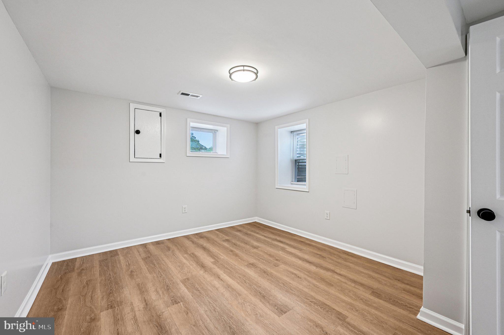 3569 Whiskey Bottom Road Laurel, MD 20724 - Photo 32 of 53 an empty room with wooden floor and windows