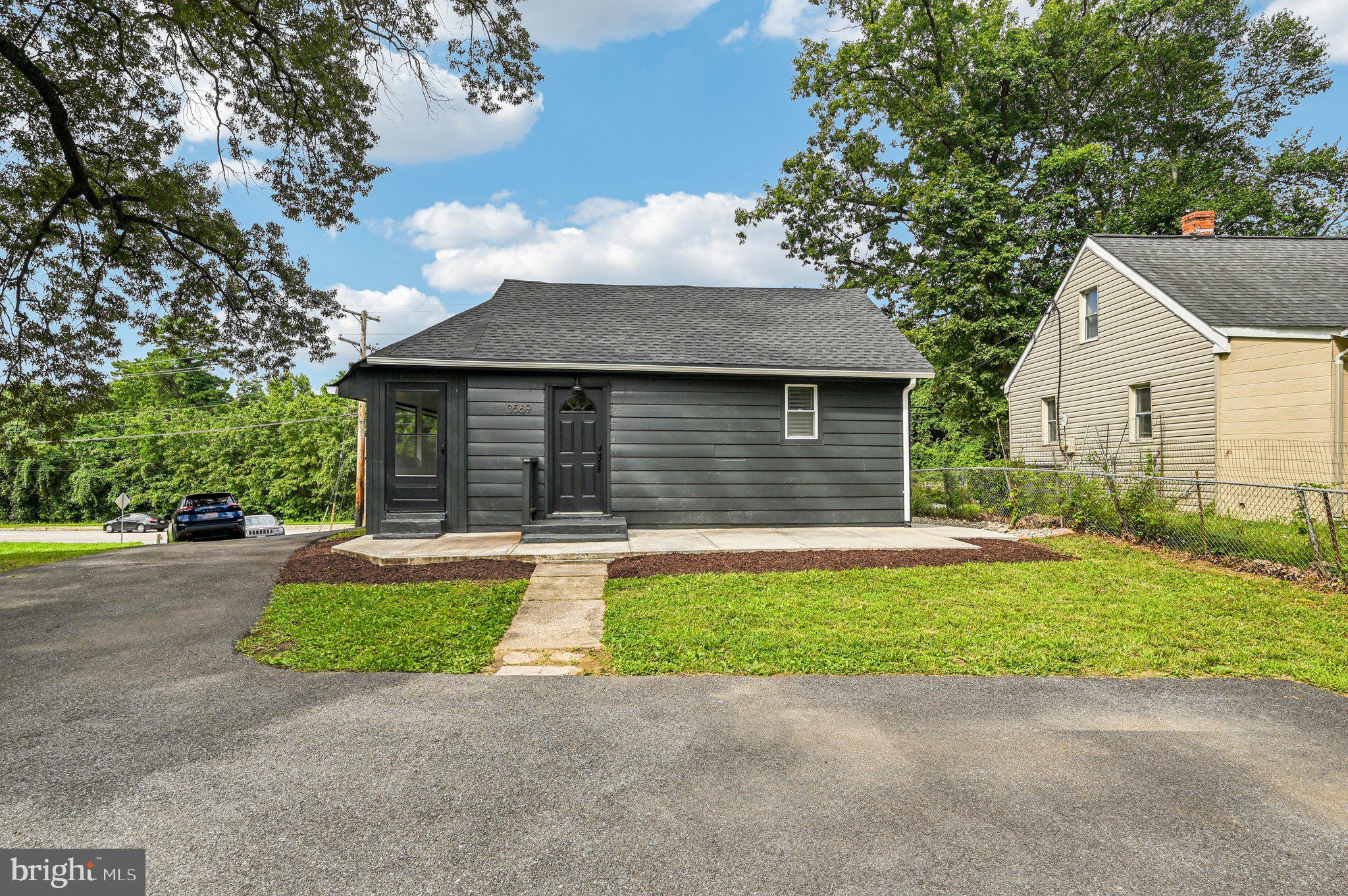 3569 Whiskey Bottom Road Laurel, MD 20724 - Photo 7 of 53 a front view of a house with a yard and garage