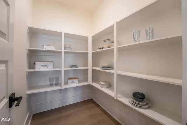 a room with a wooden floor and shelf