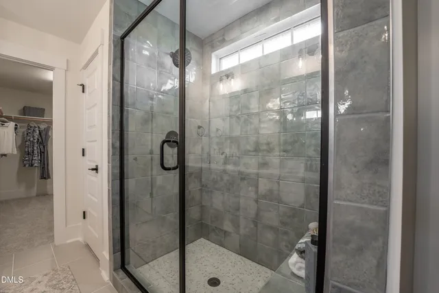 a bathroom with a glass shower door