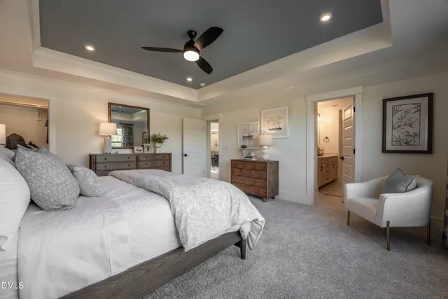 a spacious bedroom with a bed and ceiling fan