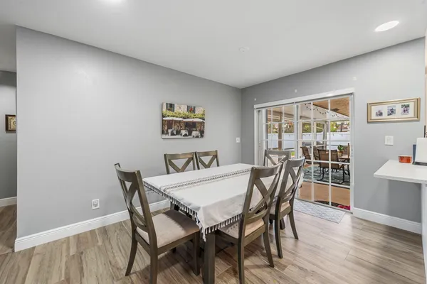 a view of a dining room with furniture and wooden floor