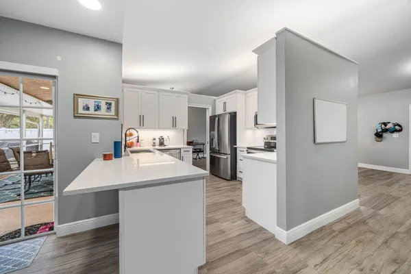 a kitchen with refrigerator and cabinets