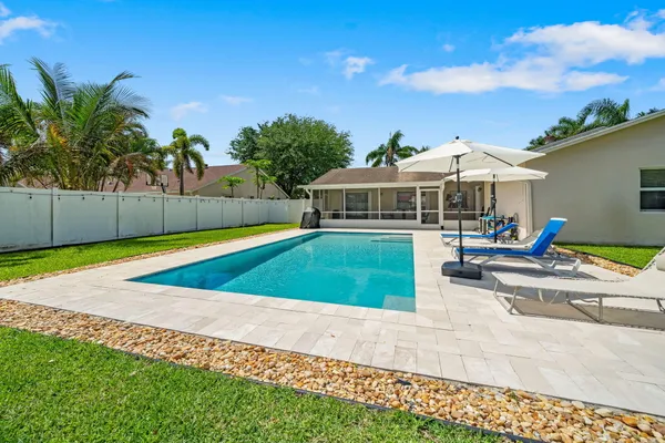 a view of house with swimming pool outdoor seating