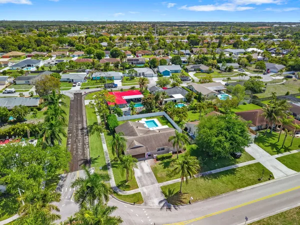 an aerial view of a house with a yard and a garden