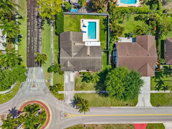 an aerial view of a house with a yard