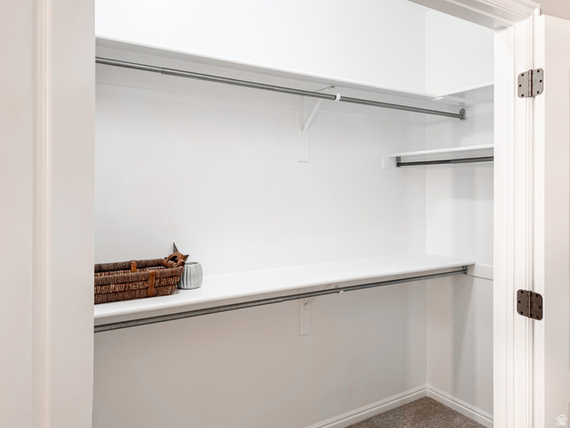 2158 Balboa Way St. George, UT 84770 - Photo 20 of 40 White-painted closet featuring multiple shelving units and metal hanging rods