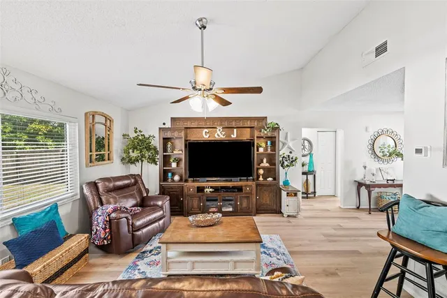 a living room with furniture and wooden floor