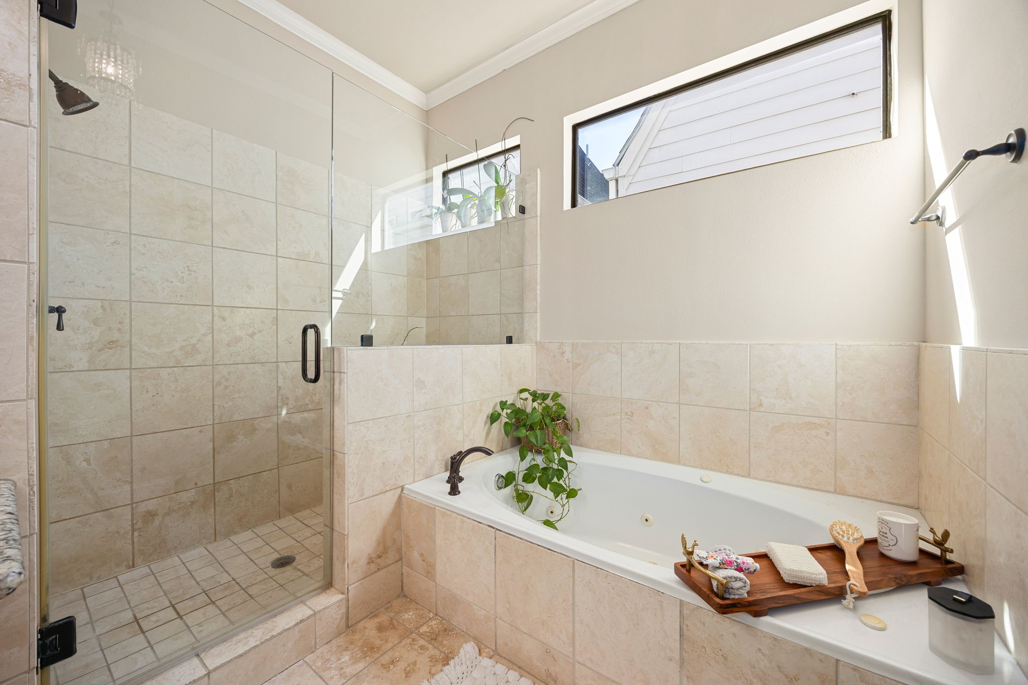 821 Lester Street Houston, TX 77007 - Photo 19 of 44 Spacious walk-in shower and a luxurious corner bathtub with elegant tiling. Natural light streams through the horizontal high windows!