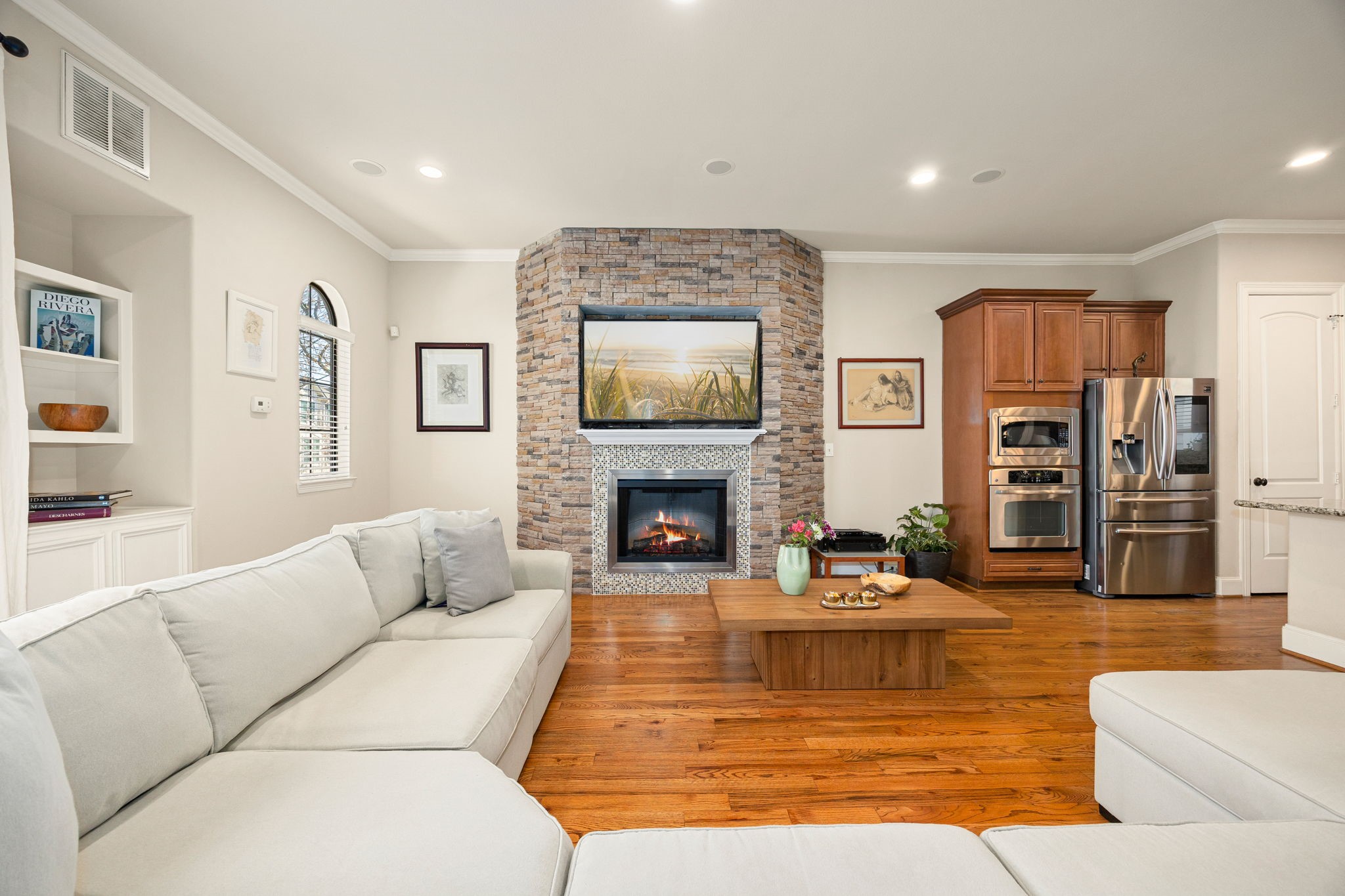821 Lester Street Houston, TX 77007 - Photo 9 of 44 This inviting living showcases the stone fireplace. You can fit large furniture pieces here!