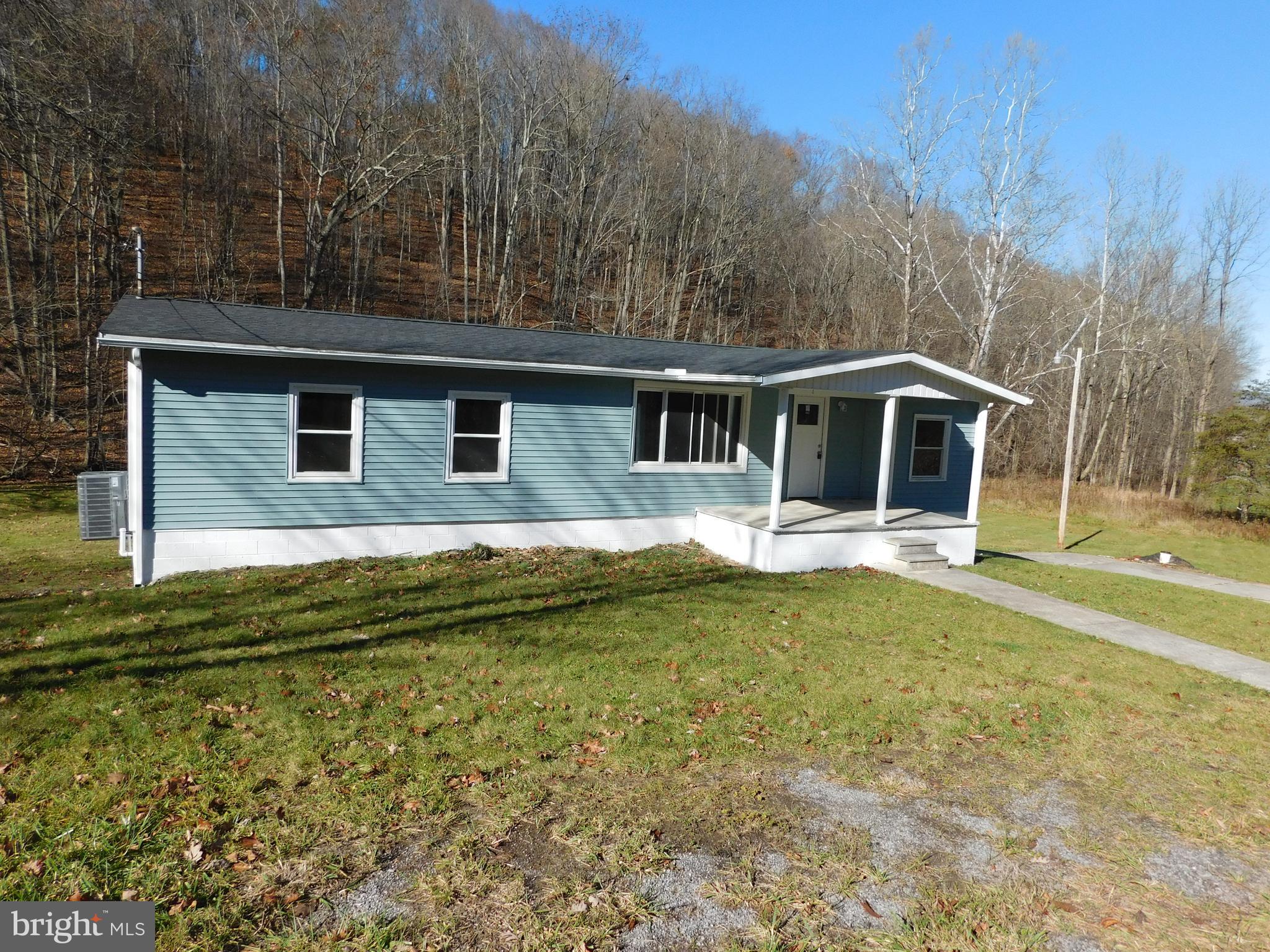 855 Shippy Road Manns Choice, PA 15550 - Photo 1 of 7 a front view of a house with a yard