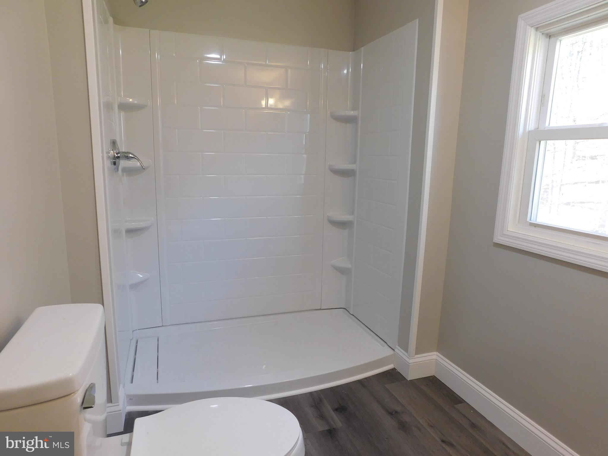 855 Shippy Road Manns Choice, PA 15550 - Photo 7 of 7 a bathroom with a toilet and a shower