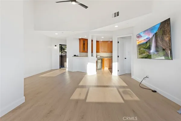 a kitchen with stainless steel appliances a refrigerator sink and cabinets