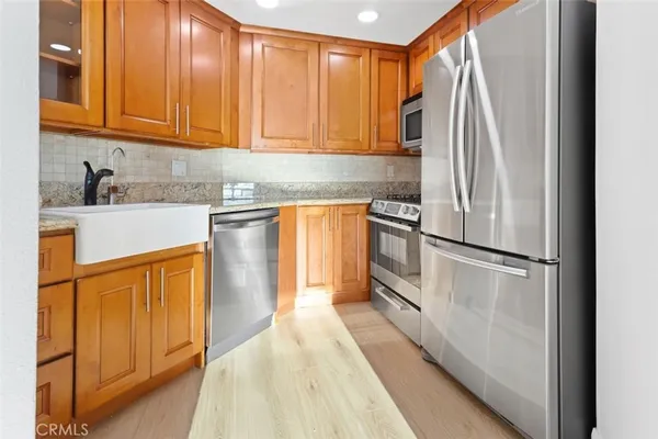 a view of kitchen with granite countertop cabinets