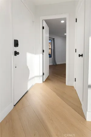 a view of a room with wooden floor and windows