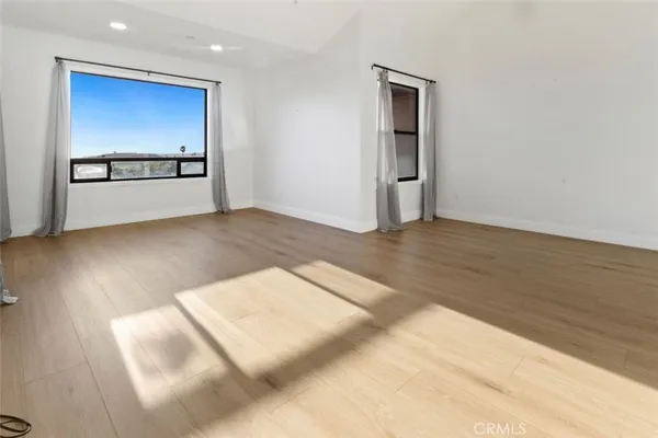 a view of a room with window and wooden floor